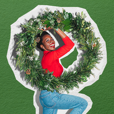 An image of a woman holding a large wreath