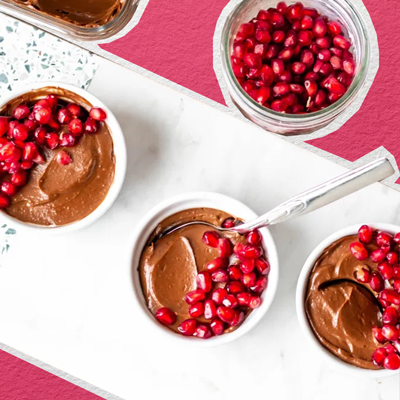 An image of vegan chocolate mousse with pomegranate seeds