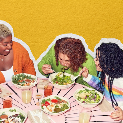 An image of a group of people eating salad at a table